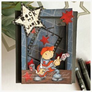 A shodow box card with the digital stamp Rock My World from All Dressed Up Stamp. I gave the boy a stage to play his music.