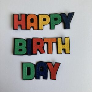 Sentiment Happy Birthday  Die-cut letters Happy Birthday in rainbow colours.