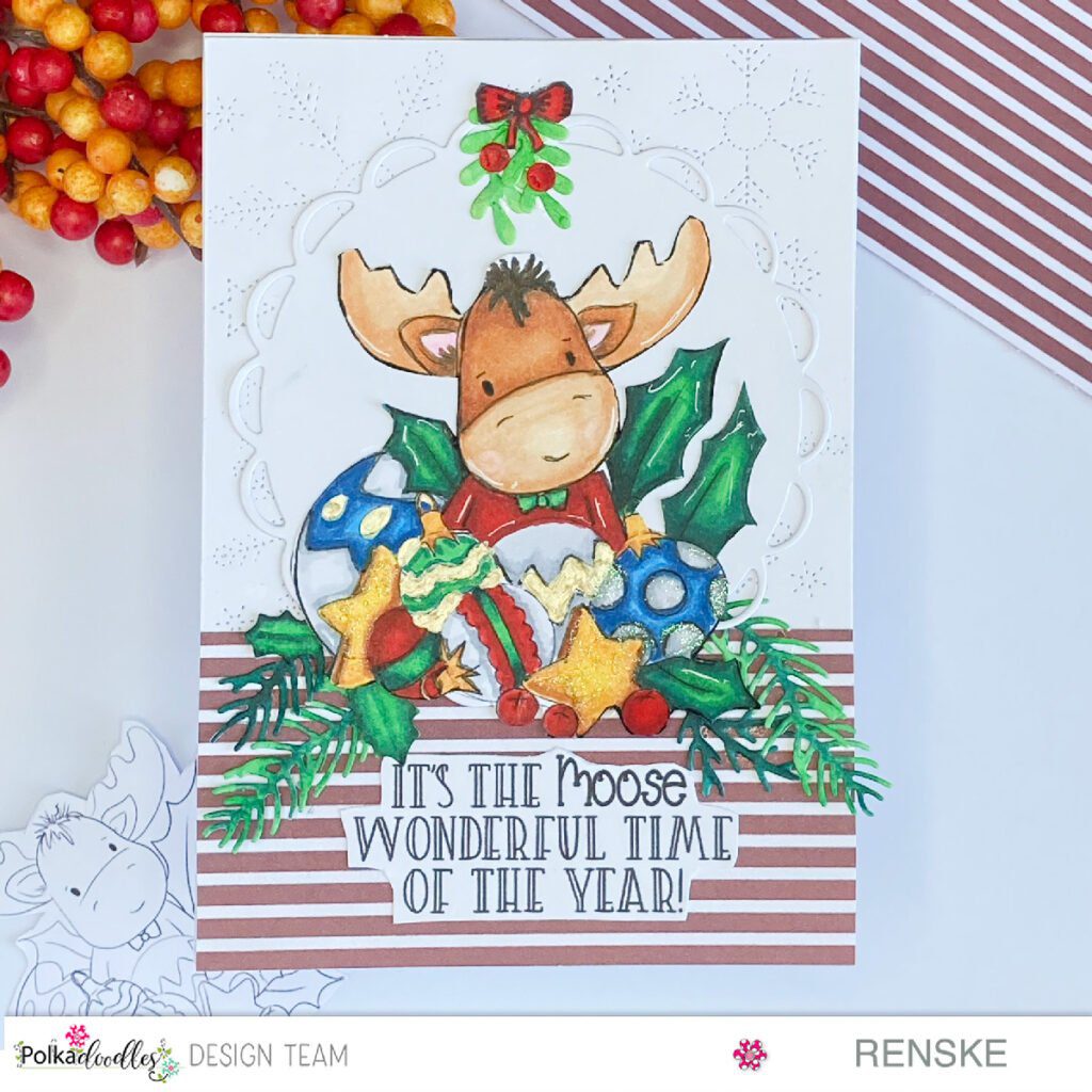 Festive Christmas in July card featuring Polkadoodles' Elvis Wesley Moose. Handcrafted with love and colored using alcohol markers. The moose is surrounded by holly, ornaments, and stars on a charming patterned background. Joyful and magical holiday vibes captured in this handmade creation.