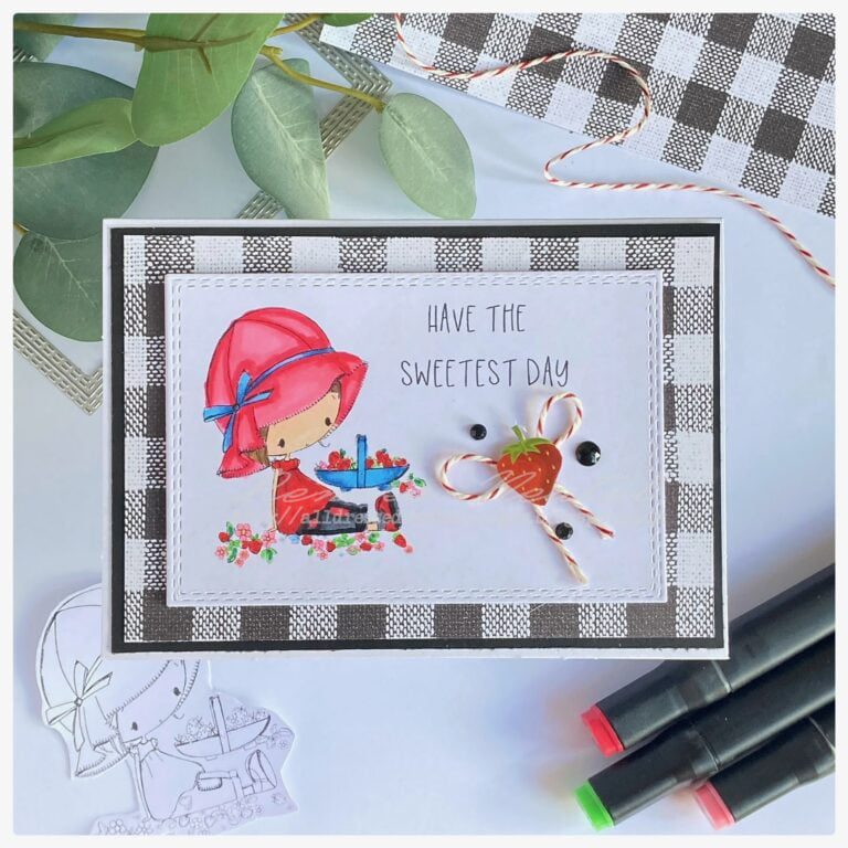 Handmade strawberry card featuring a charming girl with a sun hat, surrounded by juicy strawberries, adorned with a delicate bow, strawberry sticker, and pearl embellishments.