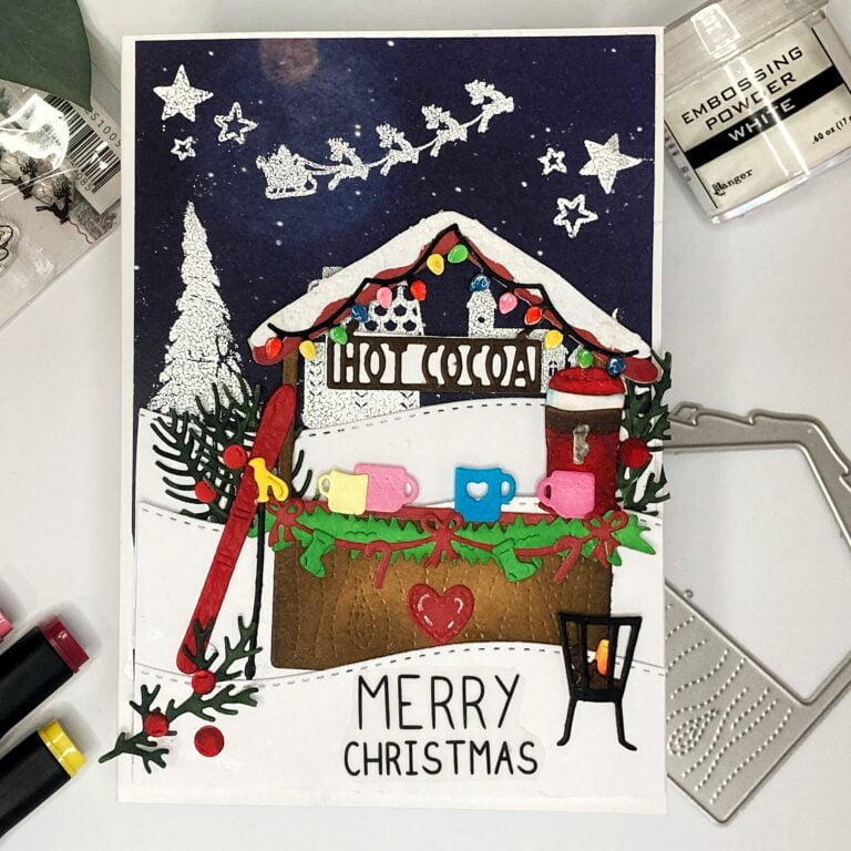 Handmade Christmas market card showcasing a cozy winter scene with a stall, snowy landscape, skis, hot cocoa, and festive details.