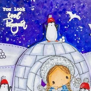 Close-up image showcasing the embossed sentiment 'You look cool penguin' on a snowy background of the handmade winter-themed card.