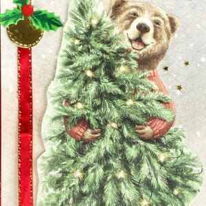 Close-up image of holiday card detail: Cheerful bear and Christmas tree adorned with glossy highlights, creating a sparkling effect on the card's design