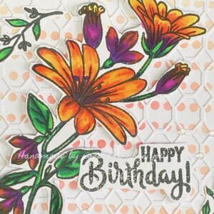 Close-up of the Coloured Floral Stamp - Vibrant purple and orange floral design, hand-coloured with alcohol markers for the floral birthday card.