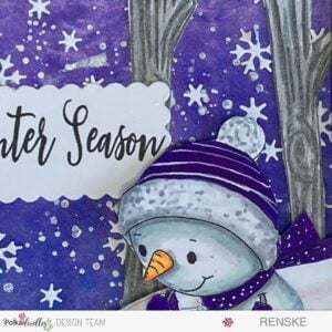 A close up picture from the background made with acrilyc paint spray. It's a purple/blue sky with meattlaic paint splatters and die-cut ice flowers and stars.