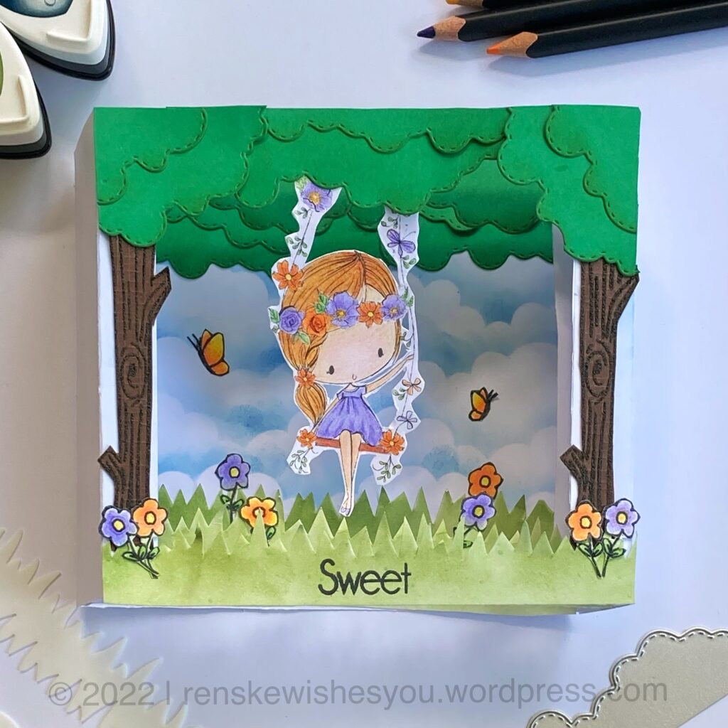 A shadow box card made with the digital stamp Fairy Swing from All Dressed Up Stamps. A girl swinging between the trees, butterflies and flowers.