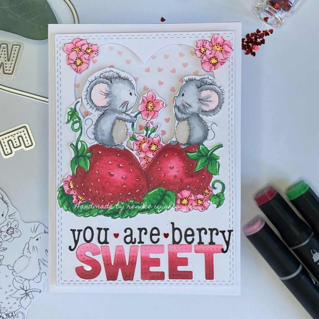 Handmade Valentine's Day Cardshowcasing two adorable mice exchanging a flower on strawberry backdrop with colorful leaves and floral accents