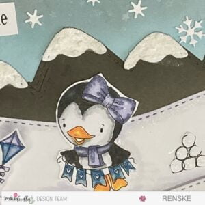 Close-up of Wanda, a hand-coloured digital stamp, holding a garland, part of a winter-themed slimline slider card featuring Polkadoodles' charming penguins