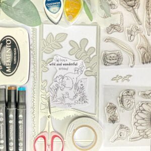 ssorted crafting materials including cardstock, markers, stencils, digital stamp, and other supplies used to create the Safari-themed Slimline Shadow Box Card.
