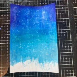 Captivating rainy background crafted with Ecoline brush pens, featuring a gradient of blues and purples, evoking the feeling of a gentle rain shower, perfect for the hedgehog card tutorial.