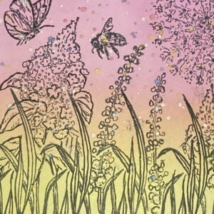 Close-up of the stamped flowers and background on the handmade card. This close-up shot reveals the intricate details of the stamped flowers and grasses, as well as the blended ink colors and metallic splatters in the background. Each element contributes to the overall beauty and charm of the handmade card.