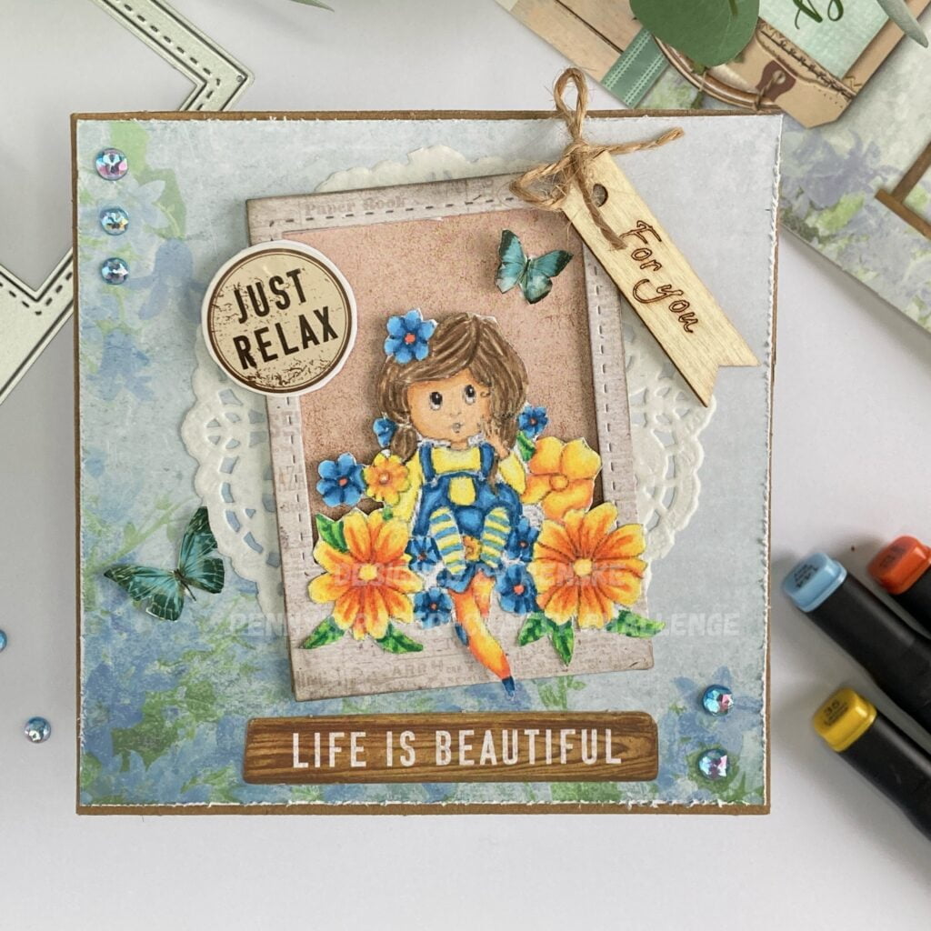 Overhead view of the complete handmade flower girl card displayed on a flat surface. The card features a Polaroid frame with a flower girl surrounded by colorful flowers.