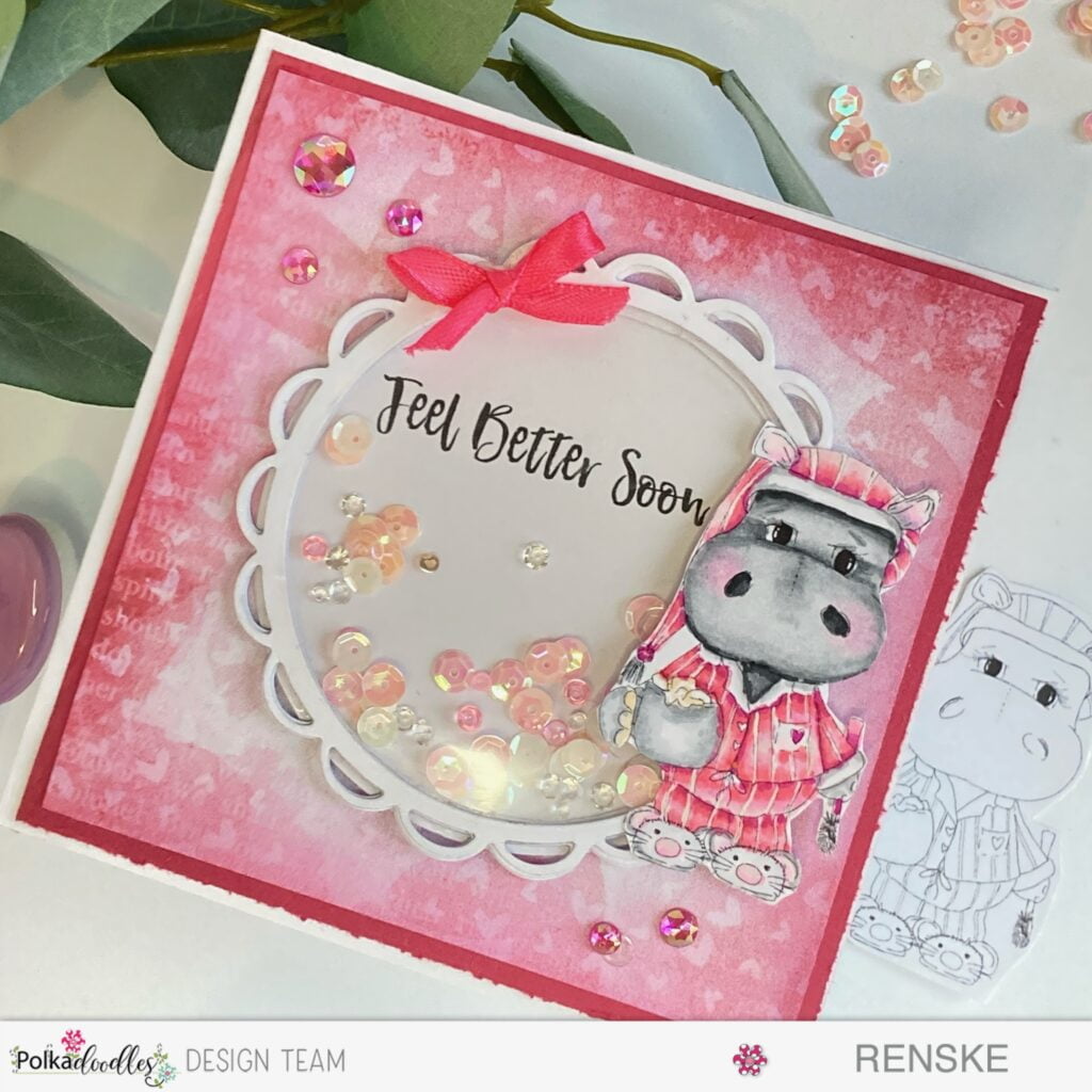 An image of a whimsical and vibrant Hippo Shaker Card, crafted with love for a feel-better occasion. Handmade with Polkadoodles digital stamps, the card showcases a delightful scene featuring a colored hippo, a shaker element, and decorative embellishments.