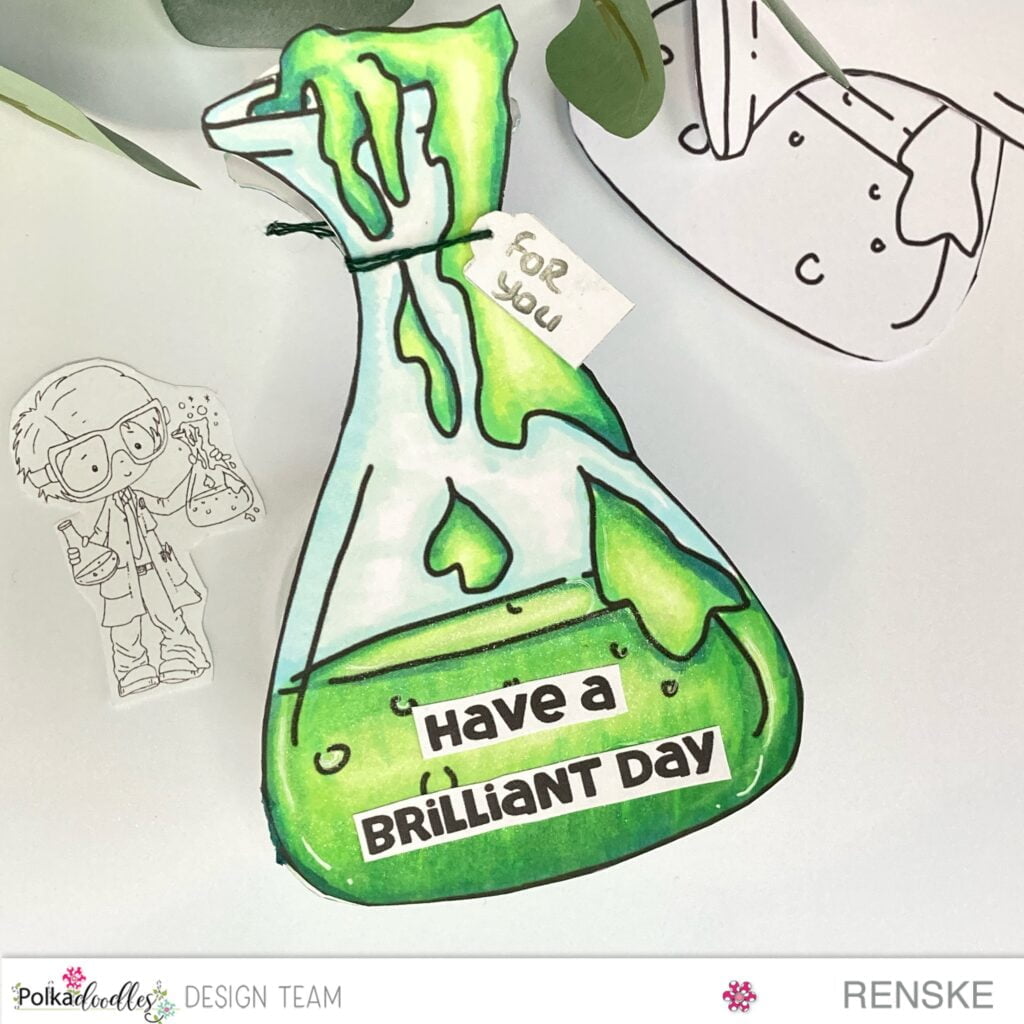 "Handmade science-themed card in bottle shape, predominantly green with blue accents, surrounded by printed digital stamps.