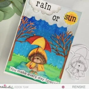 Creative handmade card showcasing a charming hedgehog digital stamp amidst a scenic background of trees and rain. This delightful card-making project offers step-by-step instructions for crafting personalized greetings.
