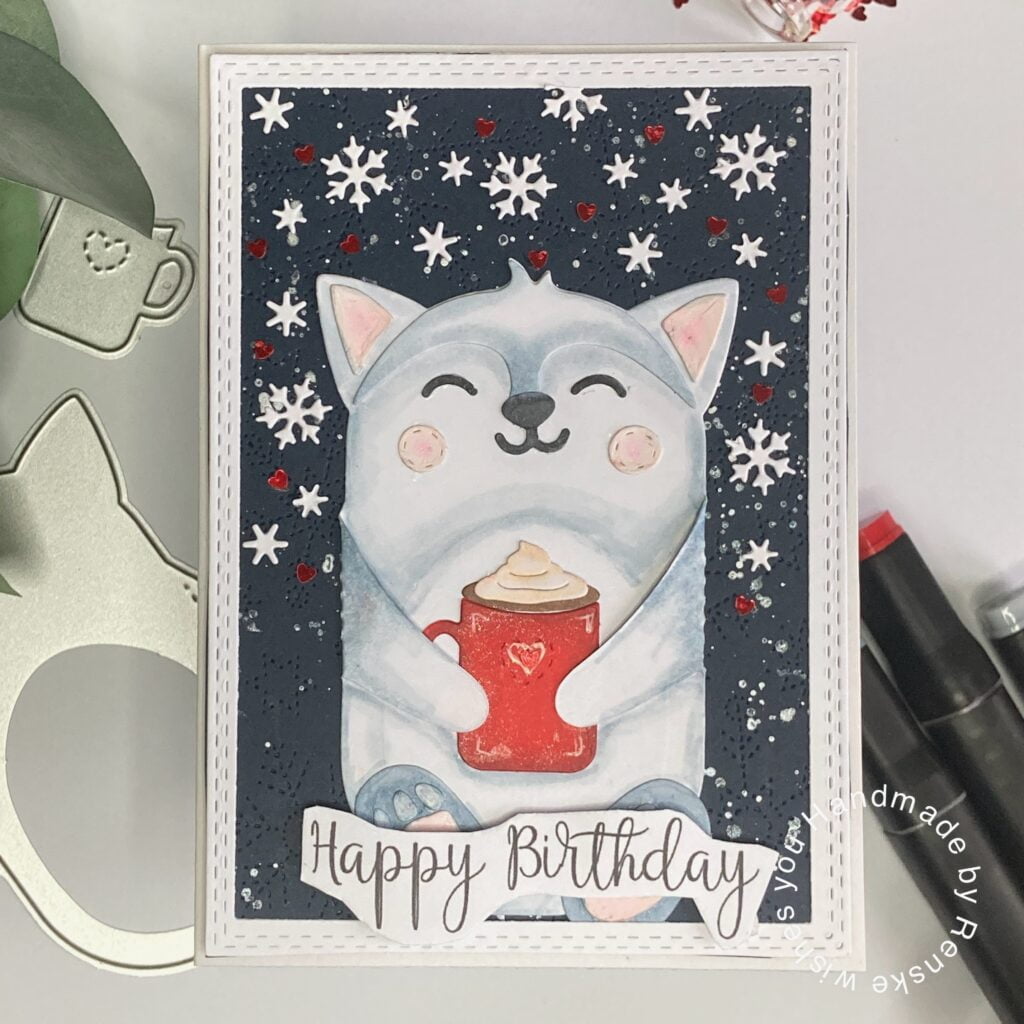 Handmade winter birthday card featuring a cute bear enjoying a cup of hot cocoa, surrounded by winter elements such as snowflakes and ice flowers