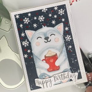 Handmade winter birthday card displayed at an angle, showcasing the intricate details and winter-themed design.
