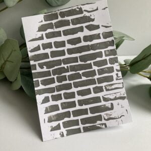 Background with the silveren crafting Mouse from Studio Mow A brick stencilled background with the silver Crafting Mousse from Studio Mow.