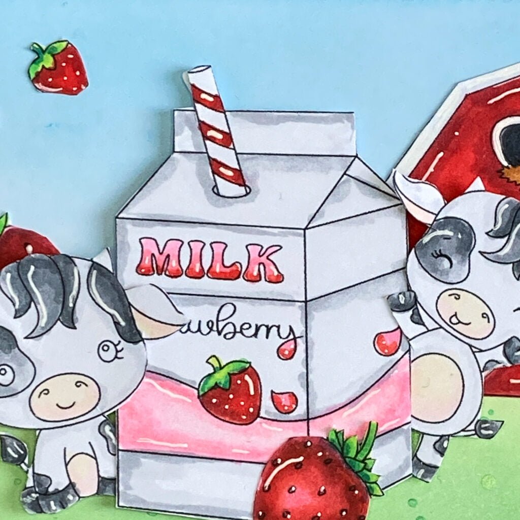 Close up picture two cows with strawberry milk carton close-up photo of the colored digital stamps featuring two cows and a milk carton. The cows are colored with shades of gray and brown, and the milk carton is adorned with shades of red and pink.