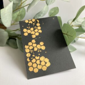 Golden crafting Mousse on a black card stock Picture of the black card stock with the golden Crafting Mousse from Studio Mow. Made with a stencil.