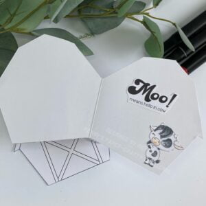 Inside of the card with sentiment and cow Top-down view of the inside of the cow greeting card, revealing the interior design with additional cow illustrations and greeting text.