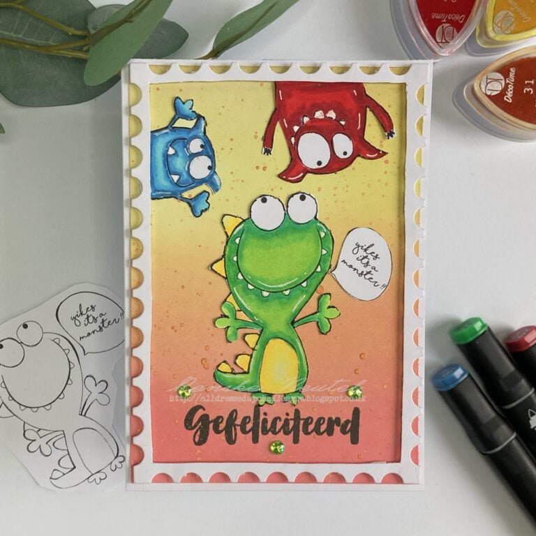 Overhead view of a handmade monster birthday card featuring three colourful monster characters: a large green monster, a blue monster, and a red monster. The card is decorated with vibrant colours and playful designs, adding a whimsical touch to the birthday celebration.