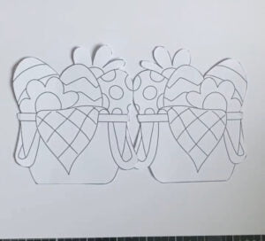 Picuter how to create the base of the shaped card Demonstrating the process of making the card base for the Easter Basket Card, with white cardstock and pencil markings indicating the shape.
