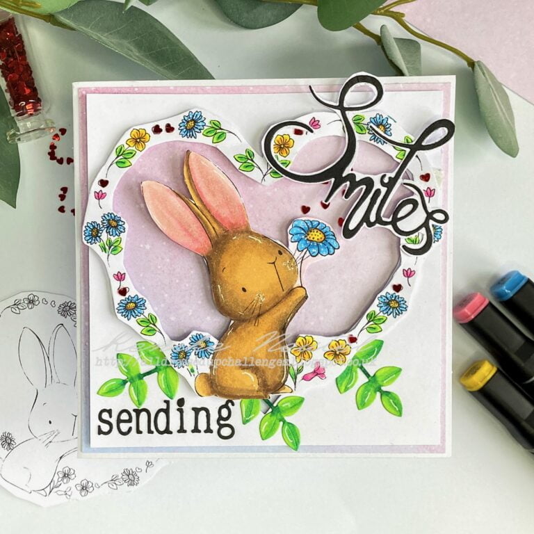A top-down view of the "Say it with Flowers" card, showcasing the complete design. The card features a heart-shaped window with a charming scene of flowers and a rabbit holding a flower, surrounded by leafy foliage.