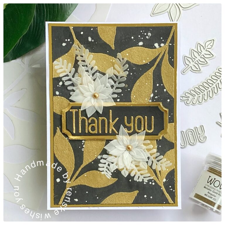 Thank you card with golden leaves on the background and vellum flowers on top of that.