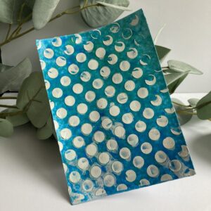 White craftig Mousse on acrylic paint background Background made with blue and green acrylic paint. On top of that there are big white dots created with the white crafting mousse from Studio Mow