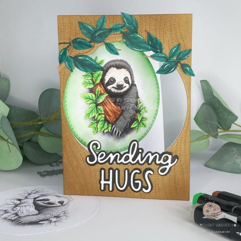 A front-facing view of the handmade sloth card, captured from the front. The card features a delightful sloth image nestled amidst branches and leaves, creating a charming scene against a textured background resembling tree bark. The sentiment "sending hugs" adds a heartwarming touch to the design, completing the handmade creation.