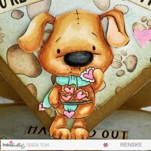 Close up picture of the coloured digital stamp Scruff dog with heart shaped cookies Close-up of the coloured digital stamp, depicting an adorable dog holding heart-shaped cookies. The intricate colouring details bring the image to life, highlighting the artistry involved in creating a handmade easel card.