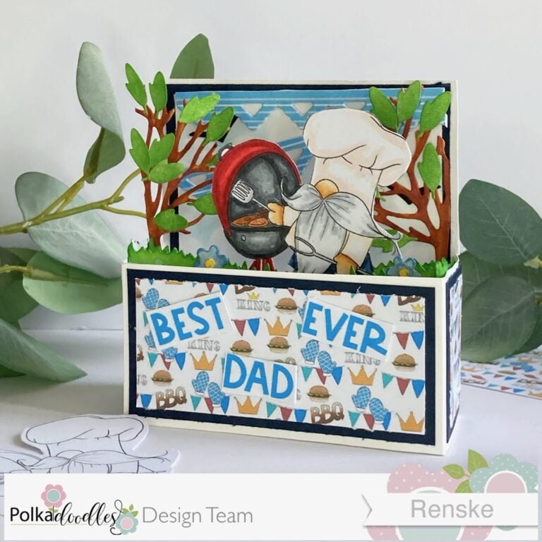 ngled view of Handmade Father's Day Card in a Box, displaying the intricate details and gnome-themed BBQ party scene, including a gnome chef cooking at the grill, surrounded by trees, flowers, and a delightful outdoor ambiance.
