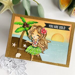 Handmade beach card Miss Lily Hawaiian Odytnetika 1 Top-down view of the beach card lying flat at an angle. The card's design elements include a brightly colored girl in a Hawaiian skirt, a palm tree, and a sunset sky. The sky is colored with red, orange, and yellow distress inks, while the sea is shaded in blue hues.
