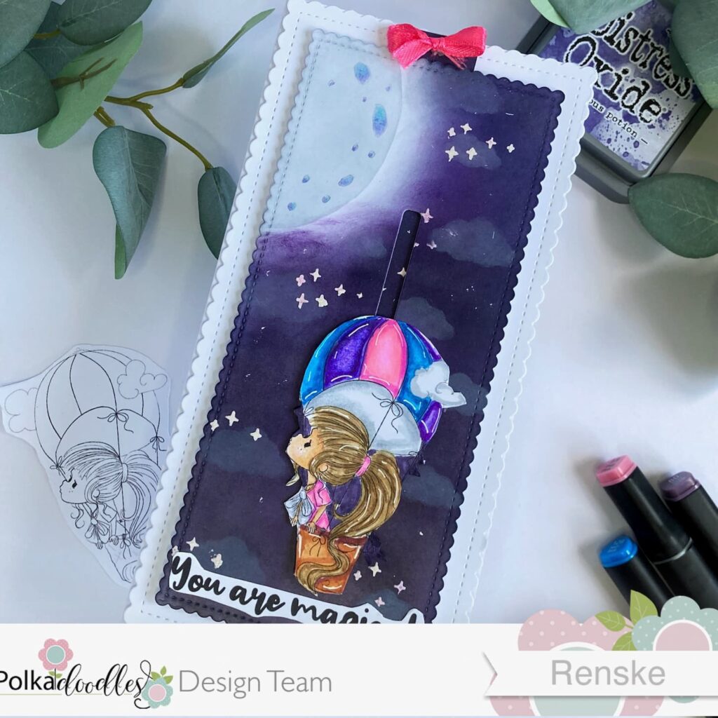 Hot Air Balloon Slider card The Sky is the Limit Polkadoodles 2 Angled top view of the hot air balloon slider card with the slider fully down. The card is positioned slightly askew, highlighting the intricate details of the night sky and hot air balloon. This card is made with this slider card tutorial.