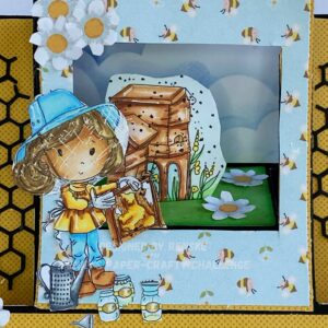 Close Up picture form the coloured Buzzy Bee Honey Digital stamp Polkadoodles Close-up of the colored digital stamp Buzzy Bee Honey featuring a beekeeper with a honeycomb, honey pots, and a watering can. The illustration includes detailed coloring with shades of tanned skin, peach, mint blue, pale yellow, and grass green. This detail from the stepper card tutorial shows the vibrant colors and fine details of the bee-themed design, including white highlights and shadow effects for added depth