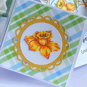 Close up picture of the coloured flower on the square side Coloured flower embellishment on the side squares of the double diamond card, adding a delicate touch to the design.