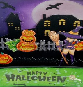 Close up picture top of the Halloween Card in a box Top-down view of a Halloween card in a box, showcasing the arrangement and layers of the card's interior elements.