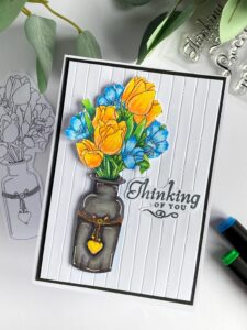 Handmade floral card Jan's Digi Stamps Top view of a handmade floral card, displaying the beautifully designed floral arrangement of yellow and blue flowers in a vase, lying flat but angled in the frame.