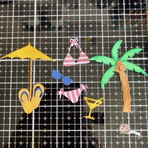 Picture of the die-cut elements of the card Die-cut elements prepared for a summer themed card with a swimming pool background.