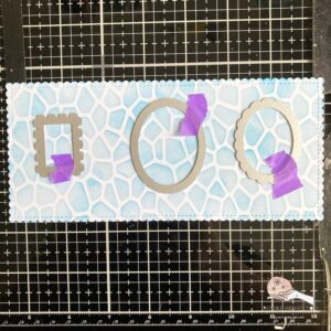 Picture of the pool background with small dies on it. Swimming pool background with die-cut pieces for a summer themed card.