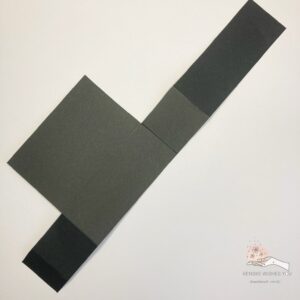 The base of the card in a box Black card base for a Halloween card in a box with visible fold lines and cut-out sections, showing the unassembled box before folding.