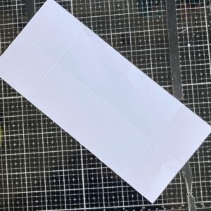 scored card base Double-diamond card base with scored lines visible, showcasing the initial steps in card making.