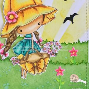 Close up from the bottom of the background panel ose-up of the bottom section of the Flower Girl card, highlighting the die-cut grass and additional flowers. The layered grass pieces and colorful flowers complete the scene, enhancing the overall design of the card.