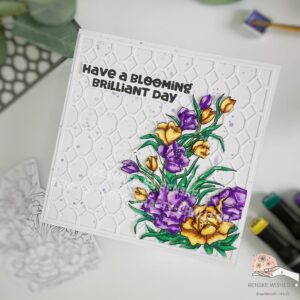 Handmade 3d floral birthday card Alex Syberia 1 In this angled top-down shot, the card is displayed slightly tilted, giving a dynamic perspective of the 3D handmade floral birthday card. The photo captures the card’s depth and layers, highlighting how the flowers pop off the page thanks to the dimensional effect. The purple metallic paint splatters on the card base add a touch of whimsy, while the background die-cut provides a beautiful textured backdrop that enhances the overall design.
