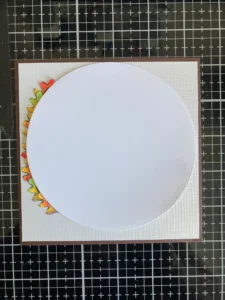 Circle sjabloon for layer the fall leaves wreath Circle template used to create an autumn leaf wreath on a fall birthday card. The circular shape serves as a guide for arranging colorful fall leaves around the design.