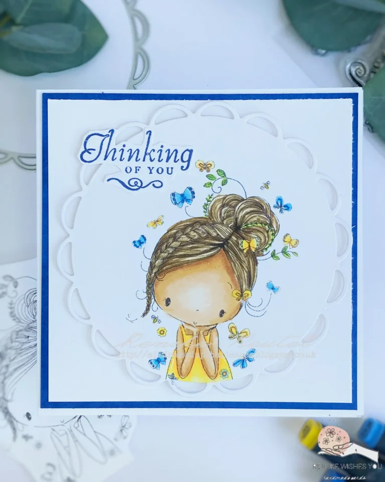 "Top-down view of a Handmade Thinking of You card featuring a clean and simple design. The card showcases a die-cut image of a girl lost in thought, framed by a scalloped circle die. The card base is blue with a white background layer, and the sentiment 'Thinking of You' is prominently displayed