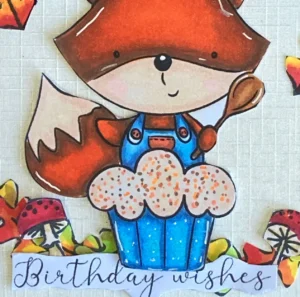 Close up Fox on sentiment birthday wishes Close-up of the 'Cupcake Fox Autumn' digital stamp and the sentiment 'Birthday Wishes' on a fall birthday card. The fox holds a cupcake, while the text adds a personal touch to this autumn-themed birthday greeting