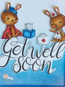 Close up coloured get well digital stamps IsabelCristina Close-up of the coloured images with alcohol markers on a handmade get well soon card, featuring a sick bunny in a red blanket, a nurse bunny, a tissue box, and a doctor's bag, highlighting the fine coloring details and blending techniques with alcohol markers