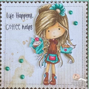 Close up picture of the coloured digital stamp and background with coffee stains. A close-up of the coloured digital stamp from the coffee-themed card, showing intricate details in the girl's hair and outfit. The background features soft coffee stains created with distress inks, adding depth and a cozy feel to the design.